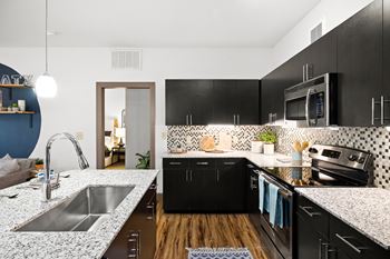 Kitchens with granite countertops and mosaic tile backsplash